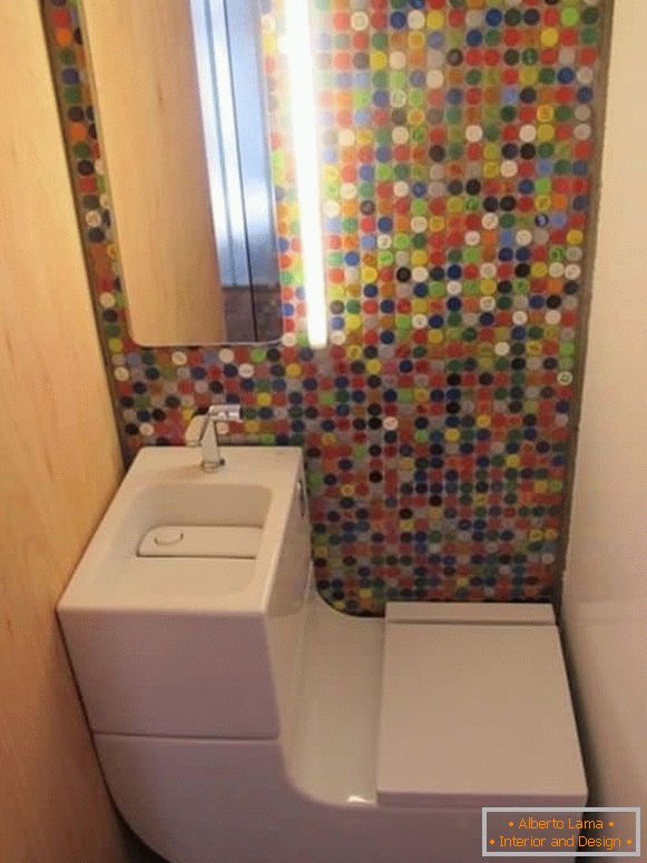 Egy kis WC modern kombinált WC-vel és világos mozaikokkal